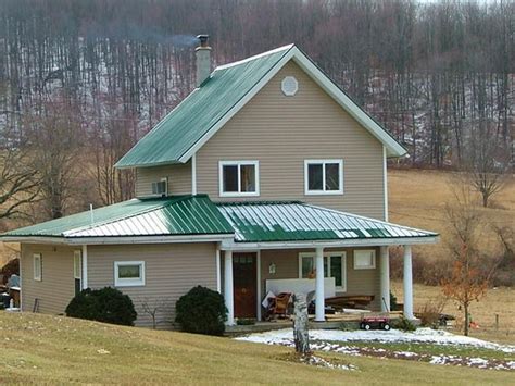 tan houses with green metal roods|green roof tan.